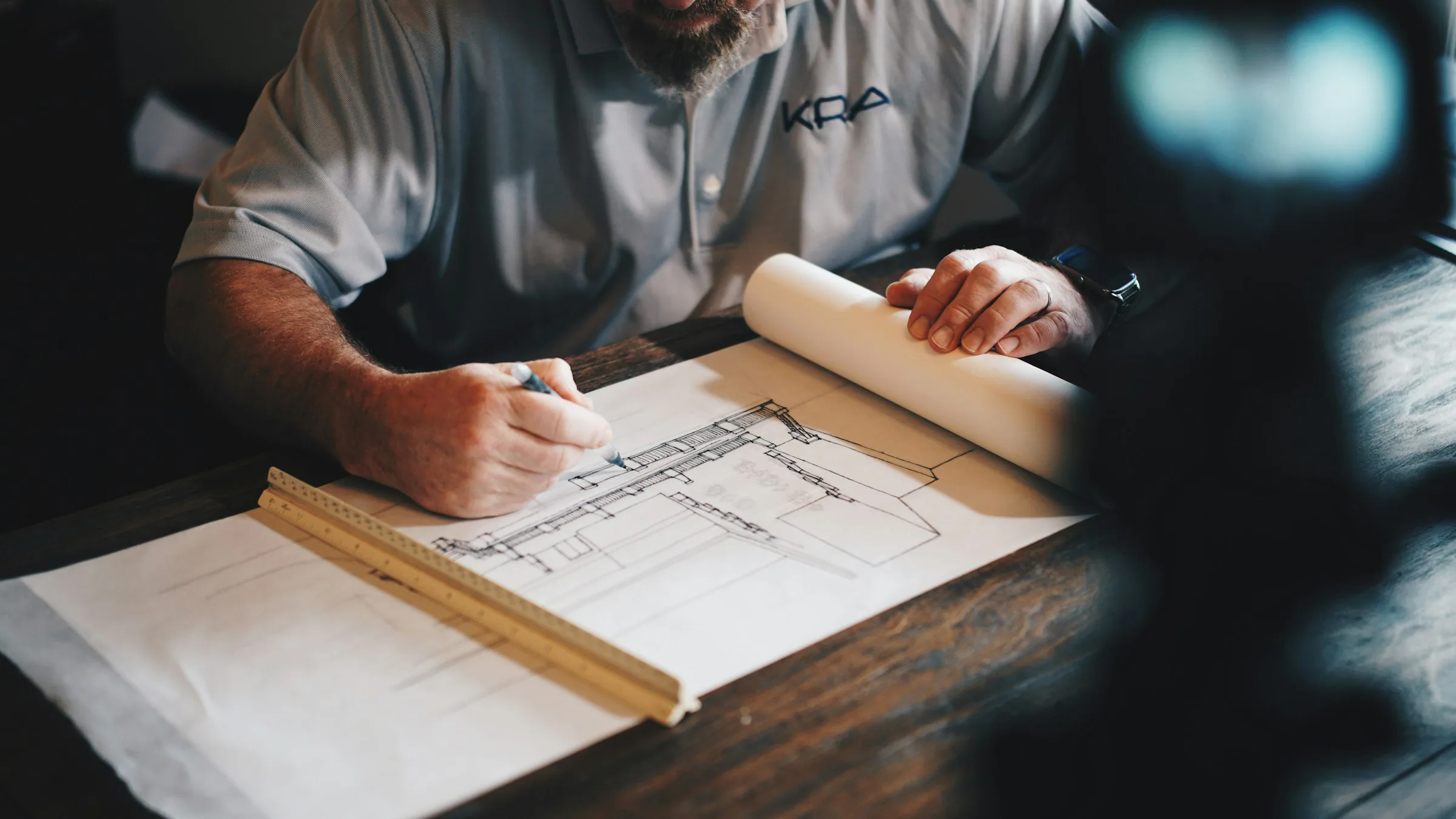 An architect drawing plans at a drafting table