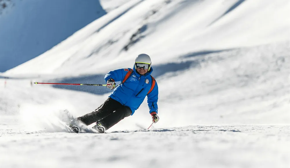 Skier carving down a slope, from the Ski.com project
